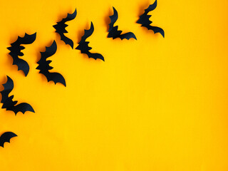 Halloween background. Bats on an orange background. Smooth layout.