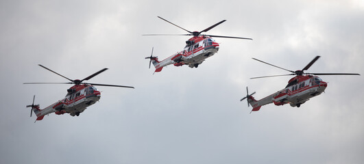 Ambulance, military or civilian helicopter on sky background.
