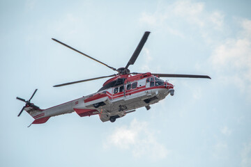 Ambulance, military or civilian helicopter on sky background.