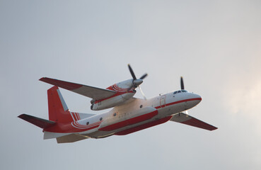 Firefighters plane in the sky close up.
