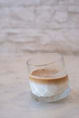 A glass of cold milk coffee or dirty coffee on The table