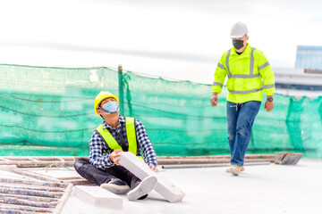 Accident at construction site. Physical injury at work of construction worker. First Aid Help a construction worker who accident at construction site. First Aid Help at accident in constructions work.