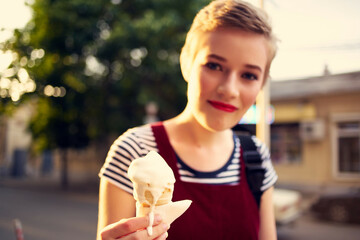 short haired woman outdoors eating ice cream walk