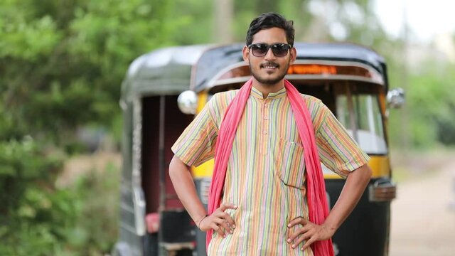 Indian auto rickshaw three-wheeler tuk-tuk taxi driver man wearing sun glasses