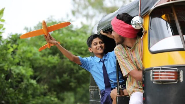 Indian auto rikshaw or tuk tuk driver with his schoolboy