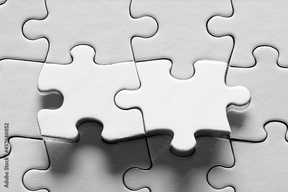 Poster jigsaw puzzle with two connected pieces are about be placed. puzzle game, solution, connection