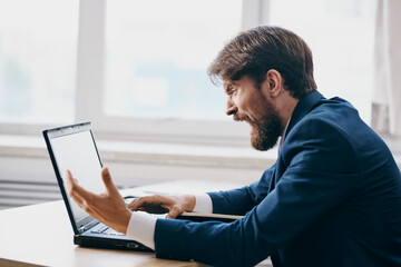 businessmen working for a laptop in the office emotions internet technologies