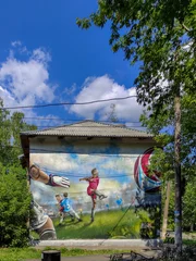 Rolgordijnen graffiti with a football player on the wall of the house © Igor