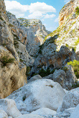 Fototapeta na wymiar (Selective focus) Stunning view of the Gorropu gorge. Gorropu is the most spectacular and deepest canyon in Europe and it is located in the Supramonte area, Sardinia, Italy.