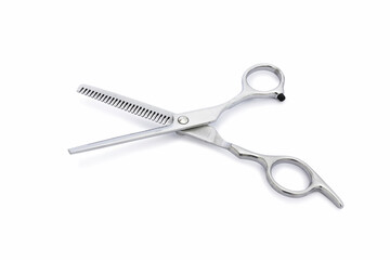 A opened silver hair cutting scissors for hair filibustering with isolated on white background.