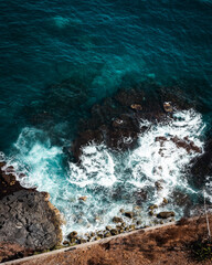 Obraz premium Top down aerial drone image of waves on the shore line in Puerto de la Cruz, Tenerife, Canary Islands, Spain. 