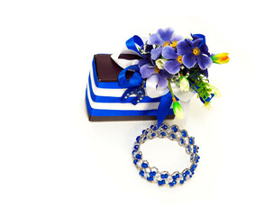 beautiful gift box. for celebration. tied with a blue ribbon. Female bracelet on his hand. blue. Women's jewelry. on an isolated white background
