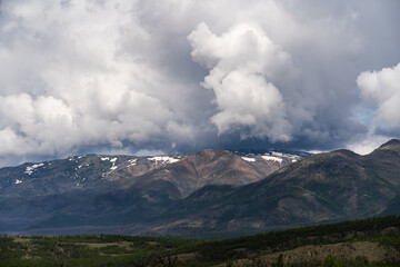 Obraz premium Inspirational mountain views. Thick gray clouds over the peaks. Travel and tourism concept.