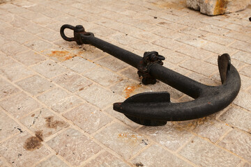  metal old anchor on the dock