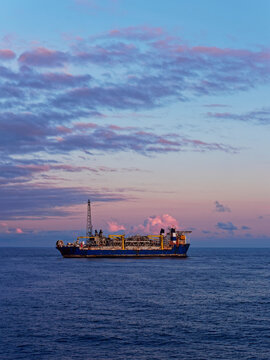 The Alvheim FPSO situated in the Norwegian North Sea attached to its Turret and undergoing maintenance Operations at Dawn.