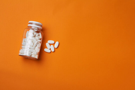 sports supplement l carnitine tablets on orange background copy space