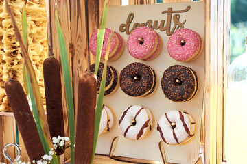 Donuts hanged on a board Delicious donuts in colored glaze