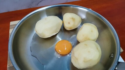 Four Peeled Potatoes with An Egg
