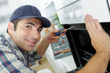 man repairing micro wave oven