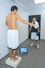 Fototapeta premium boxer stood on scales weighing in before a fight