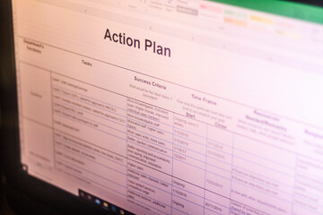 Shot of an excel sheet on computer screen showing business action plan table. Business planning