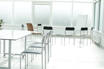 Flipchart chairs and glass table in a bright office space