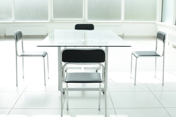 Glass table and chairs in a bright office space