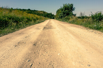 Deserted country dirt road on a summer sunny day