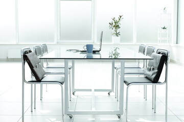 Laptop medical stethoscope coffee cup phone day planner on glass table in office space