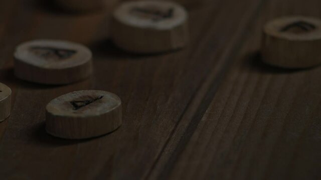 Futhark runes lie on a wooden table
