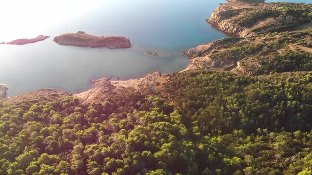 Drone footage of Rab Island, Lopar Area in Croatia. Early, calm morning after sunrise. Golden hour shoot with epic landscape, Adriatic blue sea and islets.