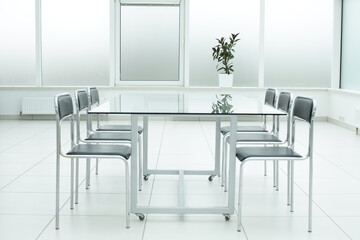 Laptop on glass table in spacious office space