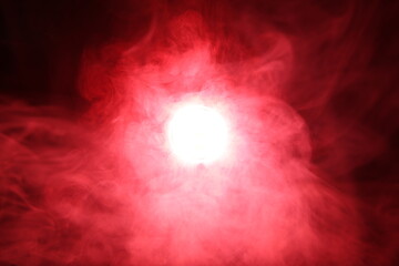 Artificial magic smoke in red light on black background - Powered by Adobe