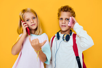 teenage boy and girl use gadgets with headphones isolated background