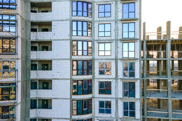 Obraz premium Aerial view of high residential apartment building under construction. Real estate development.