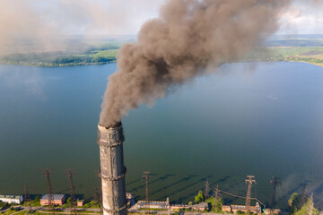 Aerial view of coal power plant high pipes with black smokestack polluting atmosphere. Electricity...