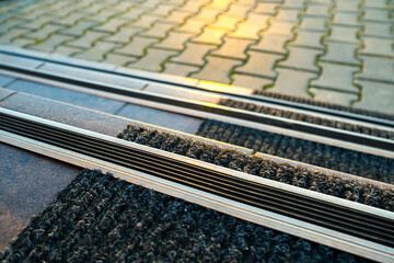 Closeup of ceramic tiles covering porch stairs with rubber anti slippery stripes on it.