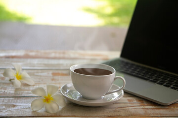Plumeria flowers with  americano, black coffee cup on a work space ,