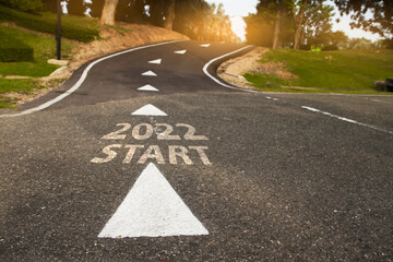 Start 2022 written on  road in the middle of empty asphalt road ..