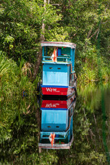 trTanjung Puting National Park, Kalimantan, Indonesia - April 2018: Traditional houseboat called a klotok on the Sekonyer River, Tanjung Puting National Park, famous for its orang-utan rehabilitation 