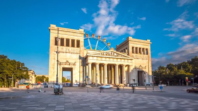 The Propylaea ( Propyl&auml;en) is a city gate in Munich, The K&ouml;nigsplatz (King's Square) most pupular square in munich hyperlapse time lapse in background riesenrad ferris wheel.