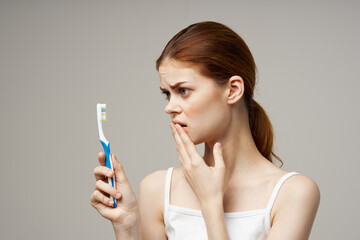 cheerful woman with a toothbrush in hand morning hygiene isolated background