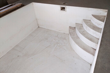 Interior of a house with big swimmig pool under renovation works.