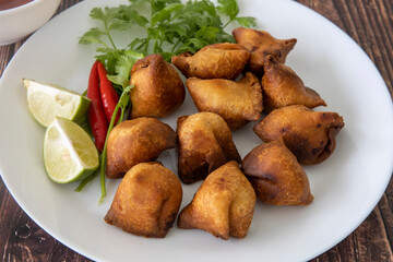 Vegetarian Samosa with potato filling on wooden table
