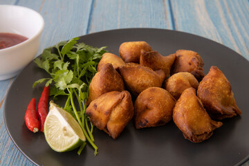 Vegetarian Samosa with potato filling on wooden table