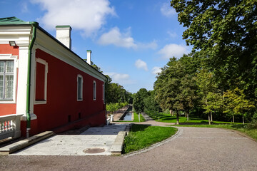 View to red and white small house in green Kadriorg park on a summer day. Blue clear sky. Stairs down. August 2021. Tallinn, Estonia, Europe