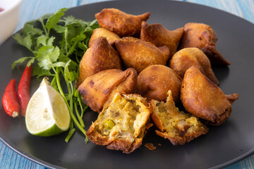 Vegetarian Samosa with potato filling on wooden table