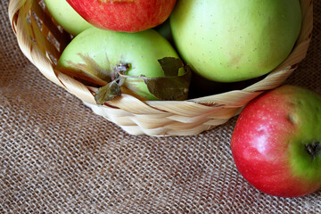 green and red apples in a wicker basket