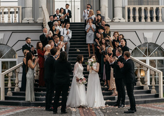 Candid shot of two female lesbian LGBT brides walking down the stairs during their wedding...