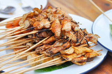 barbecued pork or spicy barbecued or spicy satay ,sausage and meatball